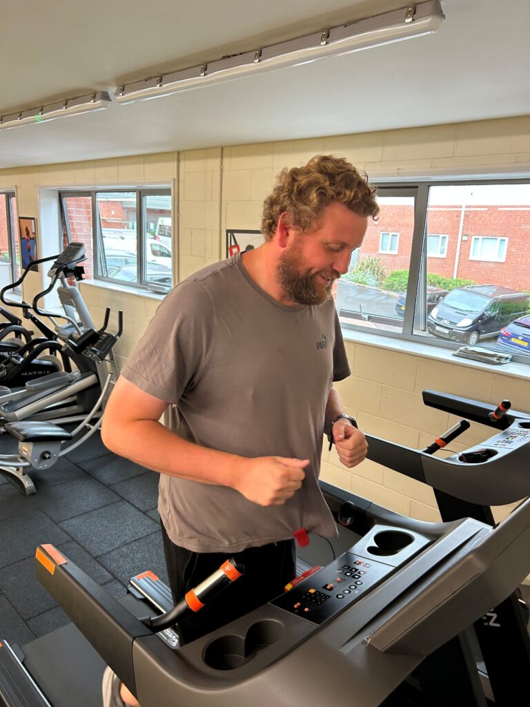 Dan, our brilliant Community Lifestyle and Gym Coordinator, is jogging on a treadmill in the Beacon Centre Gym.
